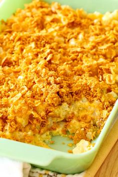 a green casserole dish filled with macaroni and cheese