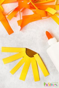 paper strips and glue are used to make an origami sun craft