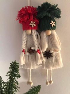 two christmas decorations hanging on the wall