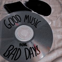 a cd with the words good music for bad days on it sitting on a bed