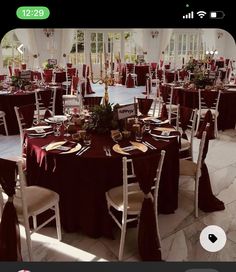 the tables are set up with red and white linens for an elegant wedding reception