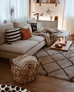 a living room filled with furniture and pillows