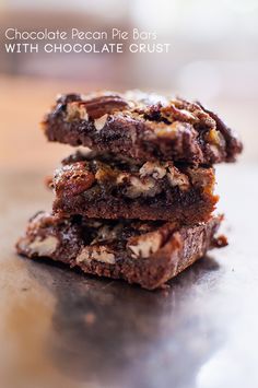 three chocolate pecan pie bars stacked on top of each other