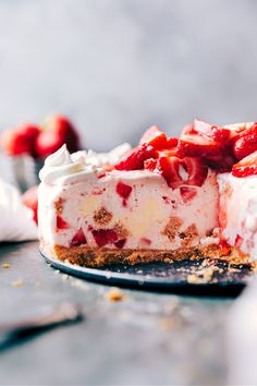 a piece of cheesecake with strawberries on top and whipped cream in the middle