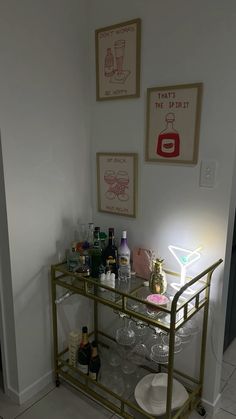 a bar cart with wine glasses and bottles on it in the corner of a room