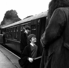 some people standing on the side of a train