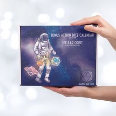 a person holding up a card with an astronaut on it