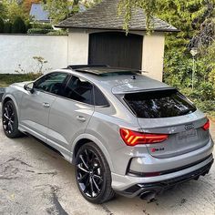 an audi suv parked in front of a house