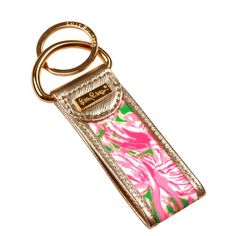 a pink and green flowered keychain with a gold metal ring on it