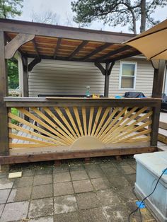 a wooden deck with an umbrella over it