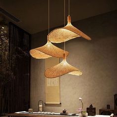 a dining room table with chairs and lights hanging from it's ceiling over it