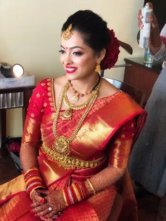 a woman in a red and gold sari