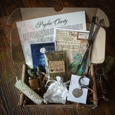 a box filled with lots of items on top of a wooden table