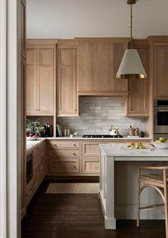 a kitchen with wooden cabinets and white counter tops, along with an island in the middle