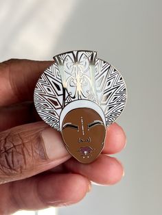 As Queen Ramonda says, “Death is not final.” Wearing all white, Queen Ramonda adorns her signature headpiece called a isicholo while solemnly celebrating her son, King T’Challa’s life. Details: Gold hard enamel 1.75 inches 2 prongs with 2 rubber backs Receive a free pair of gold locking pin backs with each pin All pins come with it's own specially designed backing card! Created by Keisha Archer for She Illustrates. Queen Ramonda, Queen Mother, White Queen, Backing Card, Pin Backs, All White, Enamel Pin, Lapel Pins, Headpiece