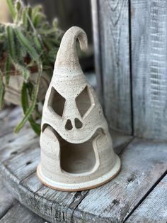 a small ceramic gnome's hat sitting on top of a wooden table