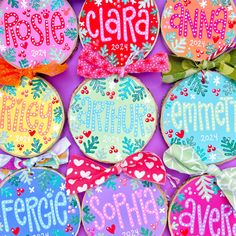 decorated cookies with the names of different countries are displayed in front of a purple background