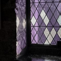 a stained glass window sitting on the side of a building