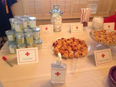 a table topped with lots of desserts and bottles of water next to each other