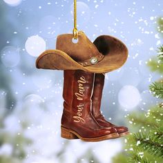 a cowboy boot ornament hanging from a christmas tree