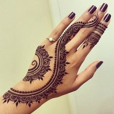 a woman's hand with henna tattoos on it