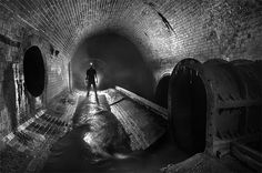 a man standing in the middle of a tunnel