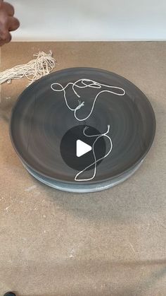 a black plate with white writing on it sitting on top of a table next to scissors