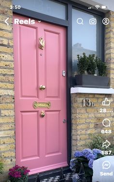 a pink front door with numbers on it