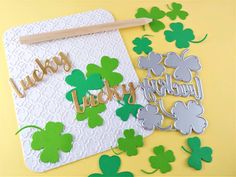 a card with shamrocks and the words happy lucky lucky on it next to some cut outs