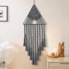 a decorative wall hanging with fringes and beads in a living room or dining room