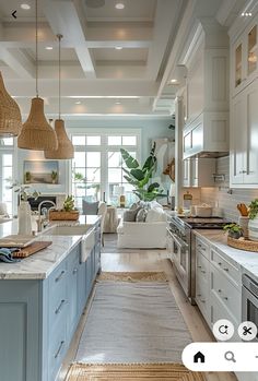 a large kitchen with blue cabinets and white counter tops, along with an area rug on the floor