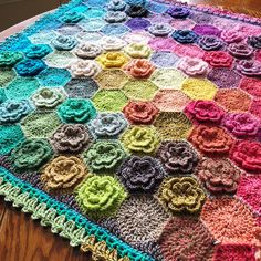 a crocheted blanket is sitting on a table