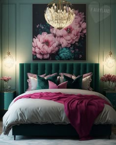 a bed with pink and green pillows on top of it next to a chandelier