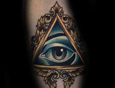 an all seeing eye tattoo on the leg, with gold and blue details around it