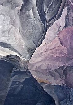 some very colorful rocks and water in the ocean or river bed, as seen from an airplane