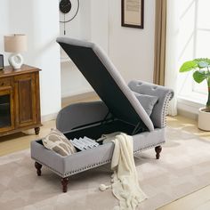 an open ottoman sitting on top of a rug in a living room