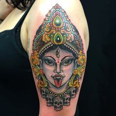 a woman's arm with a tattoo on it that has an image of a buddha