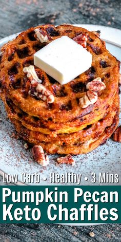 a stack of pumpkin pecan keto waffles on a plate with butter