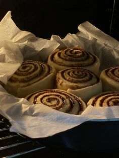 cinnamon rolls sitting in a pan on top of an oven