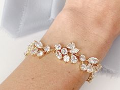 A classic and favorite among our brides, this crystal bracelet features tapering stones softly from the front to back. Each piece is handmade in the USA. DETAILS *As shown, the bracelet features crystal detailing throughout *Adjustable sizing *Finish is available in Silver or Gold, choose at checkout. The goal of your wedding accessories is to compliment your dress and your overall wedding day look, not overpower it. We want our products to make you feel beautiful and special on your wedding day Delicate Wedding Bracelet With Diamond Accents, Wedding Crystal Tennis Bracelet Sparkling, Crystal Sparkling Tennis Bracelet For Wedding, Wedding Sparkling Crystal Tennis Bracelet, Sparkling Crystal Tennis Bracelet For Weddings, White Sparkling Stones Tennis Bracelet For Wedding, Wedding Diamond Bracelet With Diamond Accents, White Sparkling Diamond Bracelet For Wedding, Gold Crystal Bracelet With Diamond Accents For Wedding