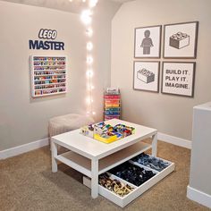 a living room with legos on the wall and toys in storage under the coffee table