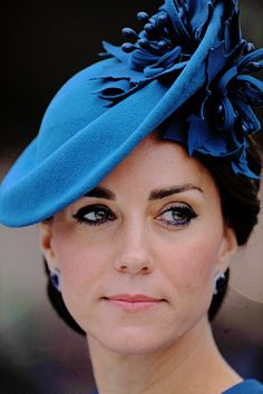 a woman wearing a blue hat with flowers on it