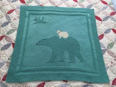 a polar bear rug on top of a quilt