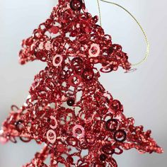 a red christmas tree ornament hanging from a string