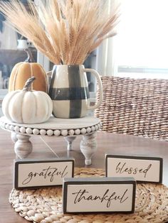 there is a table with three signs that say grateful, happy, blissful and grateful