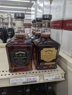 two bottles of jack daniels are on the shelf