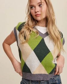 Elevate your casual style with this trendy Argyle Cropped Sweater Vest in a delightful multi-color pattern. Perfect for layering over your favorite tops! Pair it with jeans or skirts for a stylish and versatile outfit that's sure to make a statement.- Model Spec: Model is 5' 8" 30-24-35 and wearing a size Small. Style: Casual Print / Pattern: Multi color Silhouette: Oversized vest Fit: Oversized Embellishment: Ribbed with neck Neck Line: V Sleeve: Sleeveless Length: Tops 16" to 25" Closure: NA L Cropped Sweater Vest, Oversized Vest, Argyle Sweater Vest, Argyle Sweater, Versatile Outfits, Judy Blue Jeans, Contemporary Outfits, Sheer Fabric, Romper Dress