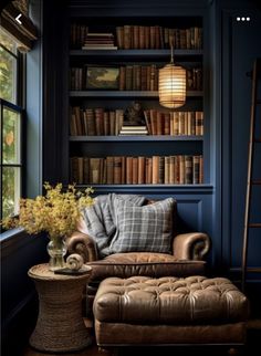 a chair and ottoman in front of a book shelf with books on the shelves behind it