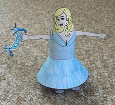 the paper doll is wearing a blue dress and holding her arms out with one hand