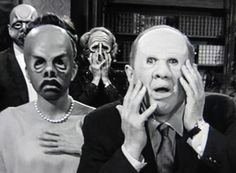 two people with masks on their faces and one person holding his head in front of them